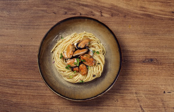 Spaghetti with mussels, without shell, pasta with peeled mussels, in carbonara sauce, micro-greens,