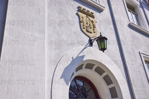 Facade of a house in the classicist style with the coat of arms of the salt boiling trade and