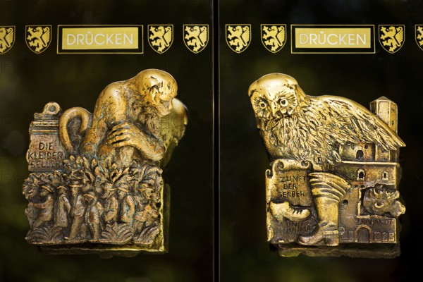 Door handles on the glass doors of the town hall with motifs from the history of the city of