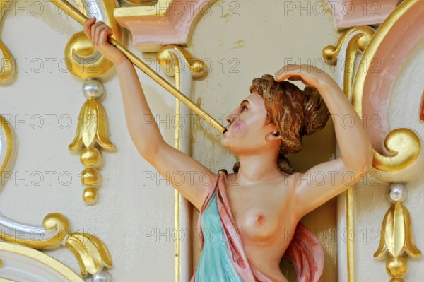 Wooden figure, colourfully painted, woman blowing fanfare, bosom free, old Hooghuys organ on
