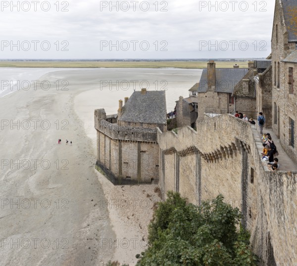 Historic buildings border an extensive sandy beach with views of the sea and the countryside, Le