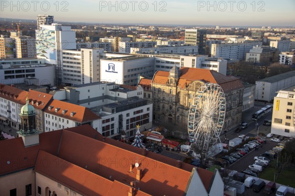 High-rise buildings in the city centre with Ferris wheel at the Christmas market, Magdeburg,