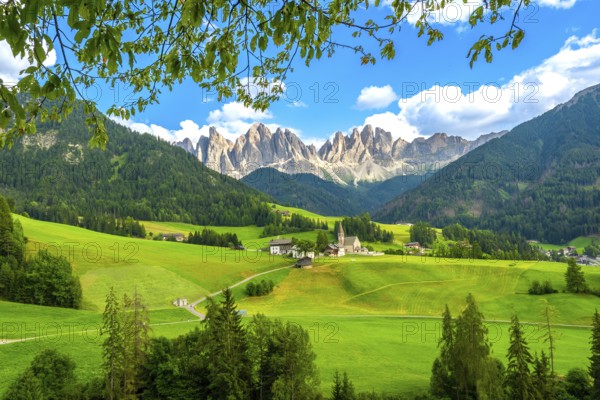 Framing the iconic santa maddalena church, green meadows and trees highlight the breathtaking