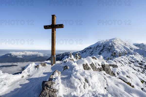 Snow-covered summit of the Jenner with summit cross in autumn, Berchtesgaden National Park,