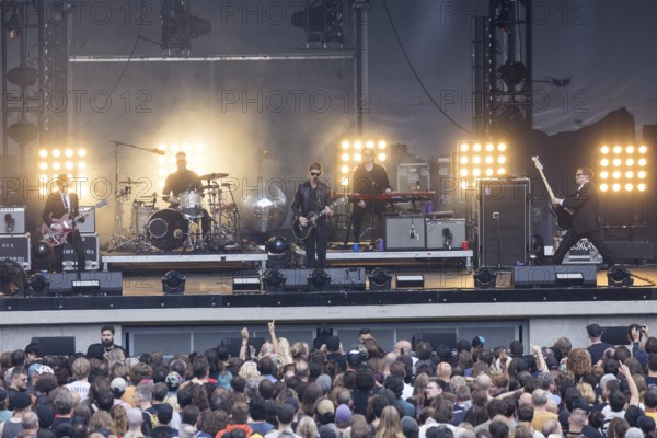 Daniel Kessler (guitarist), Samuel Sam Fogarino (drummer), Paul Banks (singer), Brandon Curtis