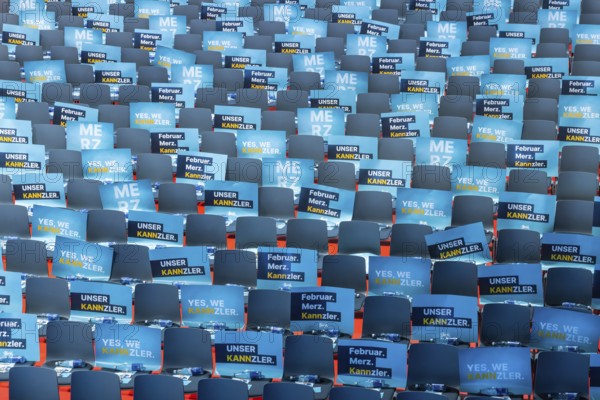 Assembly hall, deserted with many empty chairs and posters with the inscription UNSER KANNZLER.