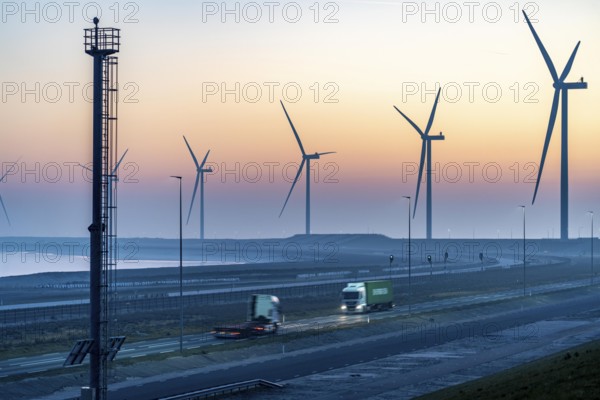 Lorry on the road to Euromax Terminal Rotterdam, ENECO wind farm on the dike around the port of
