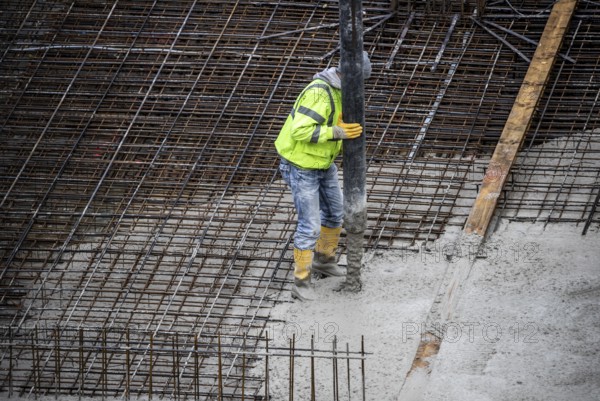 Construction site, concreting, the foundation of a building is concreted, the concrete is pumped