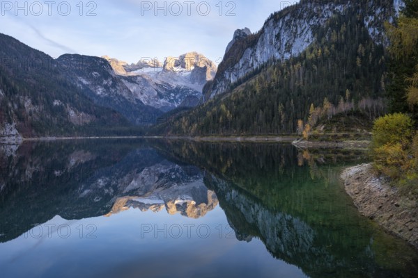 The Vordere Gosausee lake in autumn with a view of the Dachstein mountain range. The Gosaukamm on