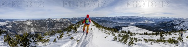 Ski tourer at the summit of Simetsberg, panorama with Walchensee, mountain panorama, Estergebirge,