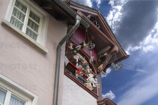 Historic roof lift bay window decorated with colourful figures, Villingen-Schwenningen,
