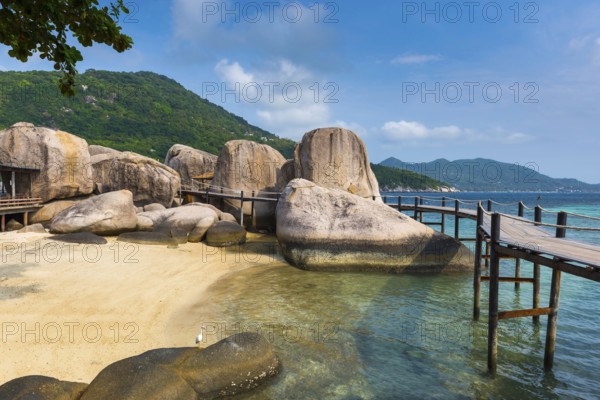 Wooden jetty with granite rocks at the entrance area of Nang Yuan Island, island, holiday island,