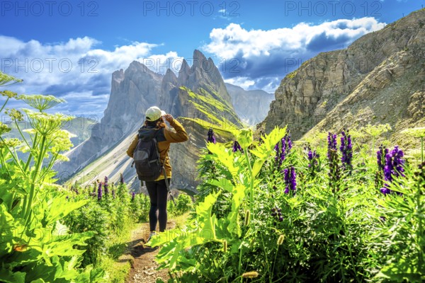 Female hiker enjoying the breathtaking view of the odle mountains on seceda during a sunny summer