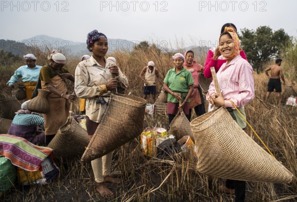 Villagers participate in a community fishing event on the occasion of the Bhogali Bihu festival at