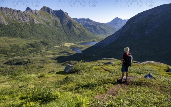Mountaineers on a hiking trail to the summit of Rundfjellet, mountain landscape and valley with