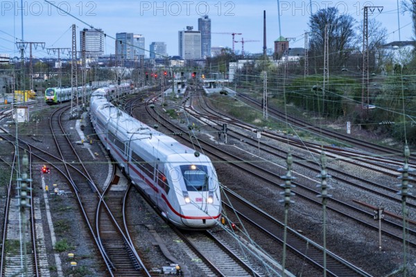Train on the tracks west of Essen central station, skyline of the city centre, ICE train, North