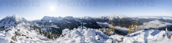Panorama, mountaineer on the snowy summit of the Jenner in autumn, view of the sea of clouds and