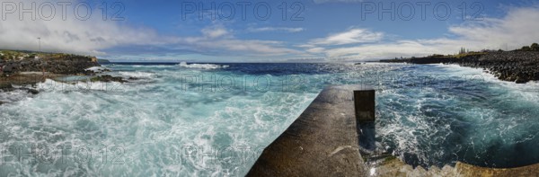 Former whale towing facility in stormy sea with waves and clouds in the sky, whale station and