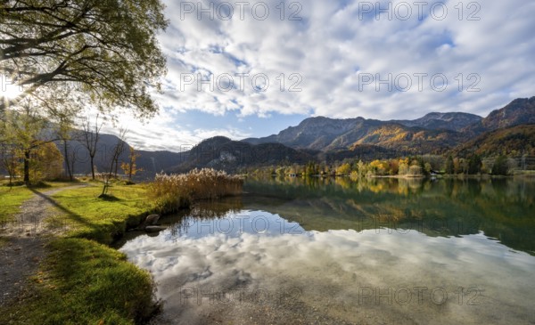 On the shore of Lake Lake Kochel with reflection, autumn landscape with mountain peaks Herzogstand