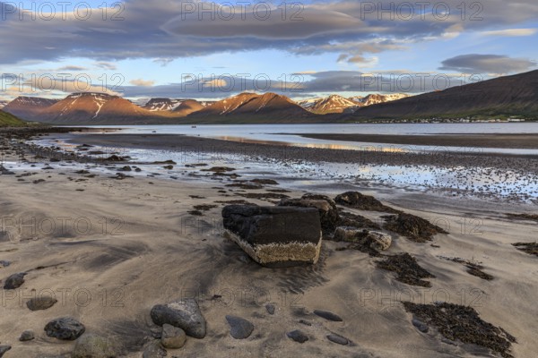 Fjord, low tide, stones, mountains, evening light, cloudy mood, Thingeyri, Westfjords, Iceland,