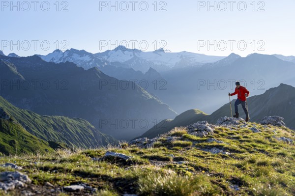 Hiker enjoying the mountain panorama in the morning, Venediger group, behind Dreiherrenkopf,