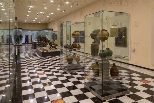 Interior of city museum, Campeche city, Campeche State, Mexico display cabinets of pottery and