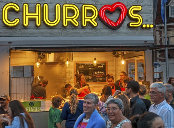 Churros stall selling fried choux pastry dough during the Gentse Feesten, Ghent city festival,