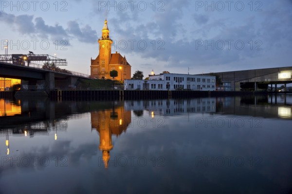 The old harbour office in the neo-renaissance style in the harbour in Dortmund at dusk, North