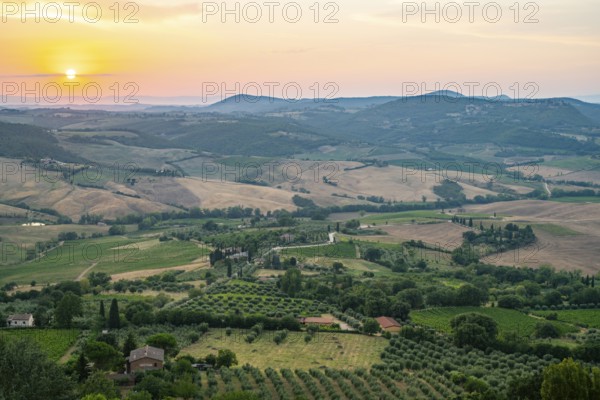 View from Montepulciano into a typical Tuscan landscape in Val d'Orcia with hills, trees, fields,