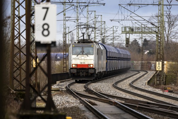 Goods train travelling on the winding Schuster Railway, overhead lines and infrastructure.