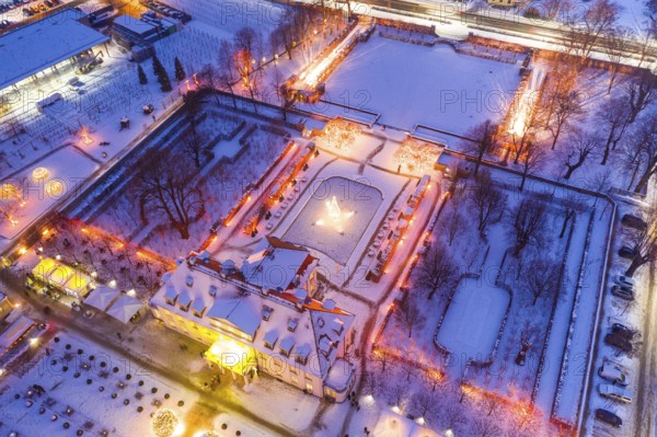 Aerial view of Wackerbarth Castle with castle park in snow and Christmas lights, Radebeul, Saxony,