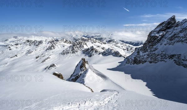 Mountain ridge of Piz Kesch, ascent on Piz Kesch or Piz d'Es-cha in winter, spectacular mountain