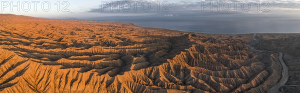 Landscape of eroded hills at Lake Issyk Kul, Badlands at sunrise, aerial view, Canyon of the