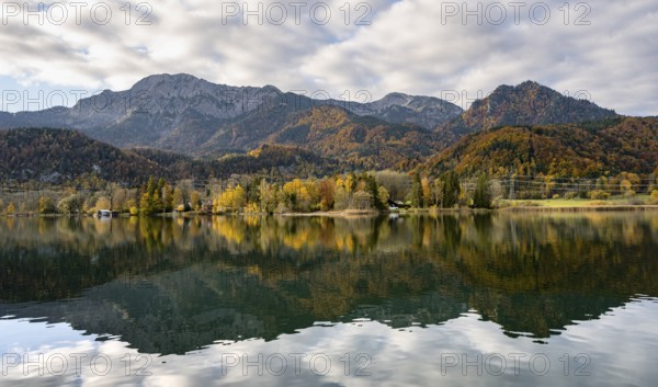 Autumnal mountain landscape with mountain peaks Herzogstand and Heimgarten, reflection in Lake