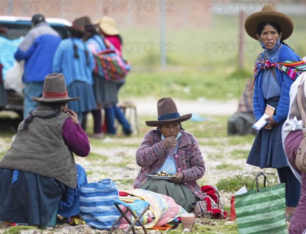 Peruvian woman in traditional traditional costume at the indigenous market in Chinchero, Cusco