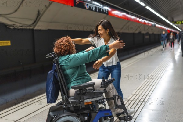 Happy disabled woman meeting a chinese female friend in the metro platform smiling and embracing