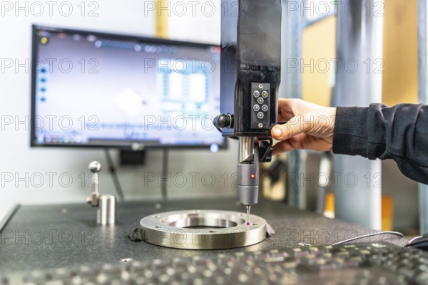 Close-up of the hand of a technician working with three-dimensional verification and measuring