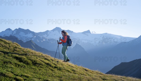 Hiker enjoying the mountain panorama in the morning, Venediger group, behind Dreiherrenkopf,