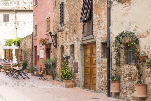 Cosy mix of old houses, shutters and street cafés in the old town of Certaldo, Tuscany, Italy,