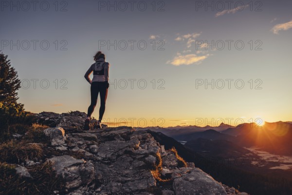 Trail running in autumn on the Jochberg on Lake Walchensee against the wonderful backdrop of the