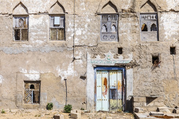 Old, weathered shutters and front door in the deserted neighbourhood of Mirbat, Dhofar Province,