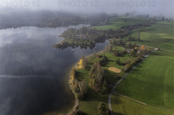 Sports facility and bathing area, lake Rottachsee, shore covered with fog, autumn, aerial view,