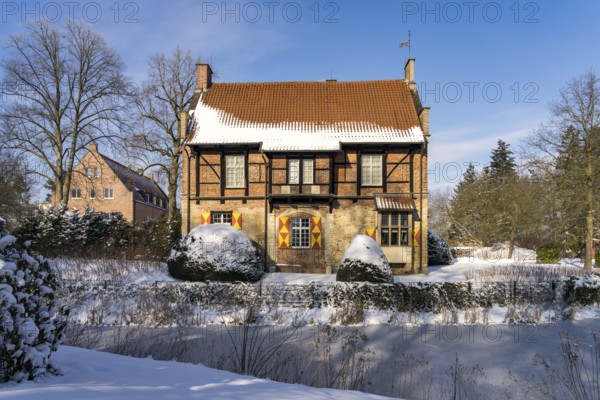 The snow-covered moated castle Haus Bisping in winter, Drensteinfurt, Münsterland, North