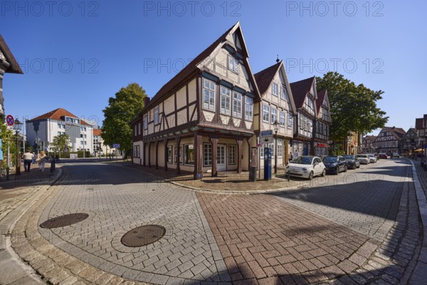Historic half-timbered houses, city centre, concrete pavement, hard shoulder with parked cars,