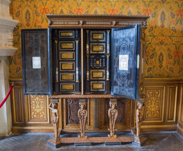Decorative antique wooden cabinet with detailed engraving and open doors, Italian cabinet in the