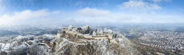 Aerial panorama of the snow-covered Hegau volcano Hohentwiel with Germany's largest castle ruins,