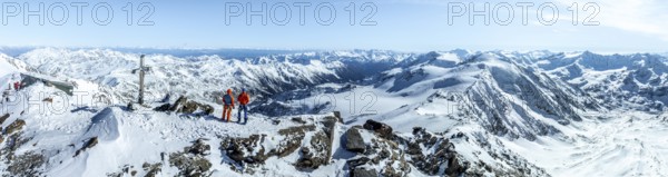 Two ski tourers on the summit of Cevedale, Alpine panorama, Aerial view, Snow-covered mountain