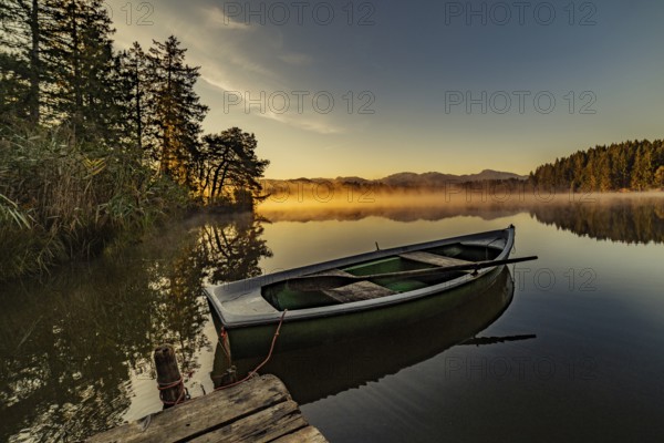 Boats in the autumnal Schmutter Weiher in the Allgäu near the municipalities of Halblech,
