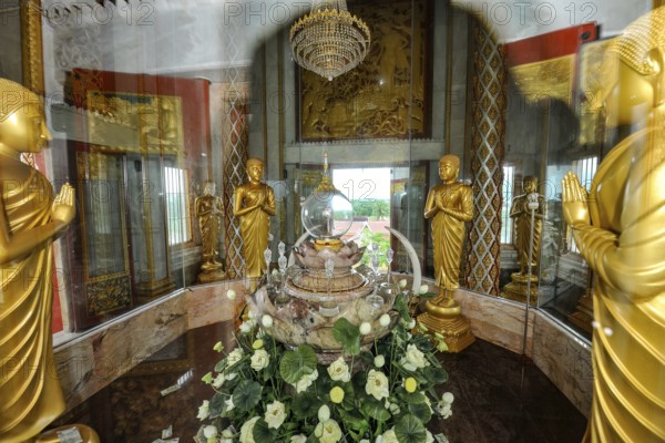 Reliquary with relics under glass in dome of tower in top of Chedi highest building in temple