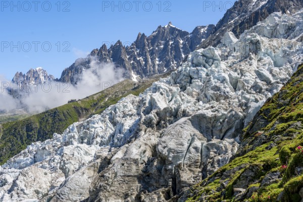Glacier ice of the Glacier des Bossons, behind pointed mountain peaks, Chamonix, Haute-Savoie,